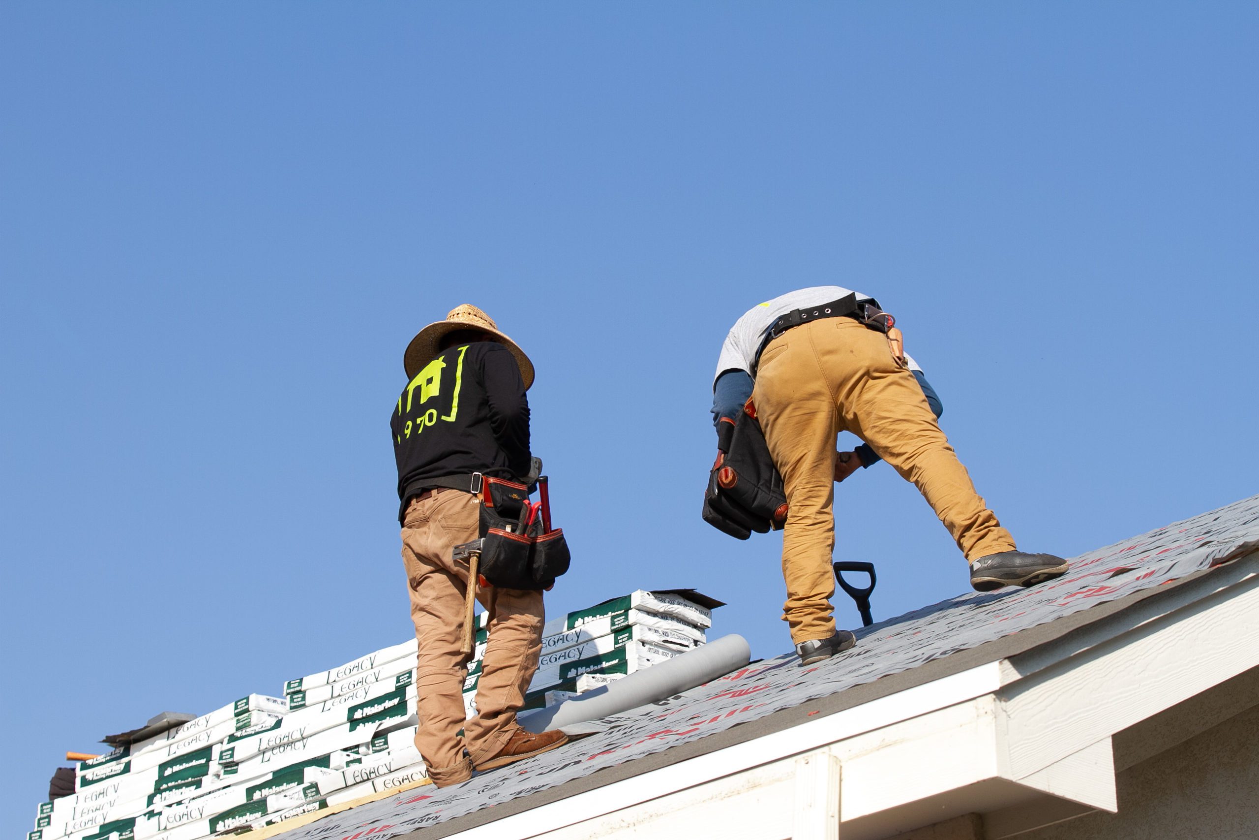 Roofers installing a new roof on a home